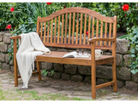 Wooden bench with a blanket and mug in a garden setting