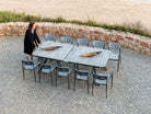 Rimini glass tempered extending dining table with 10 outdoor dining chairs on a patio area