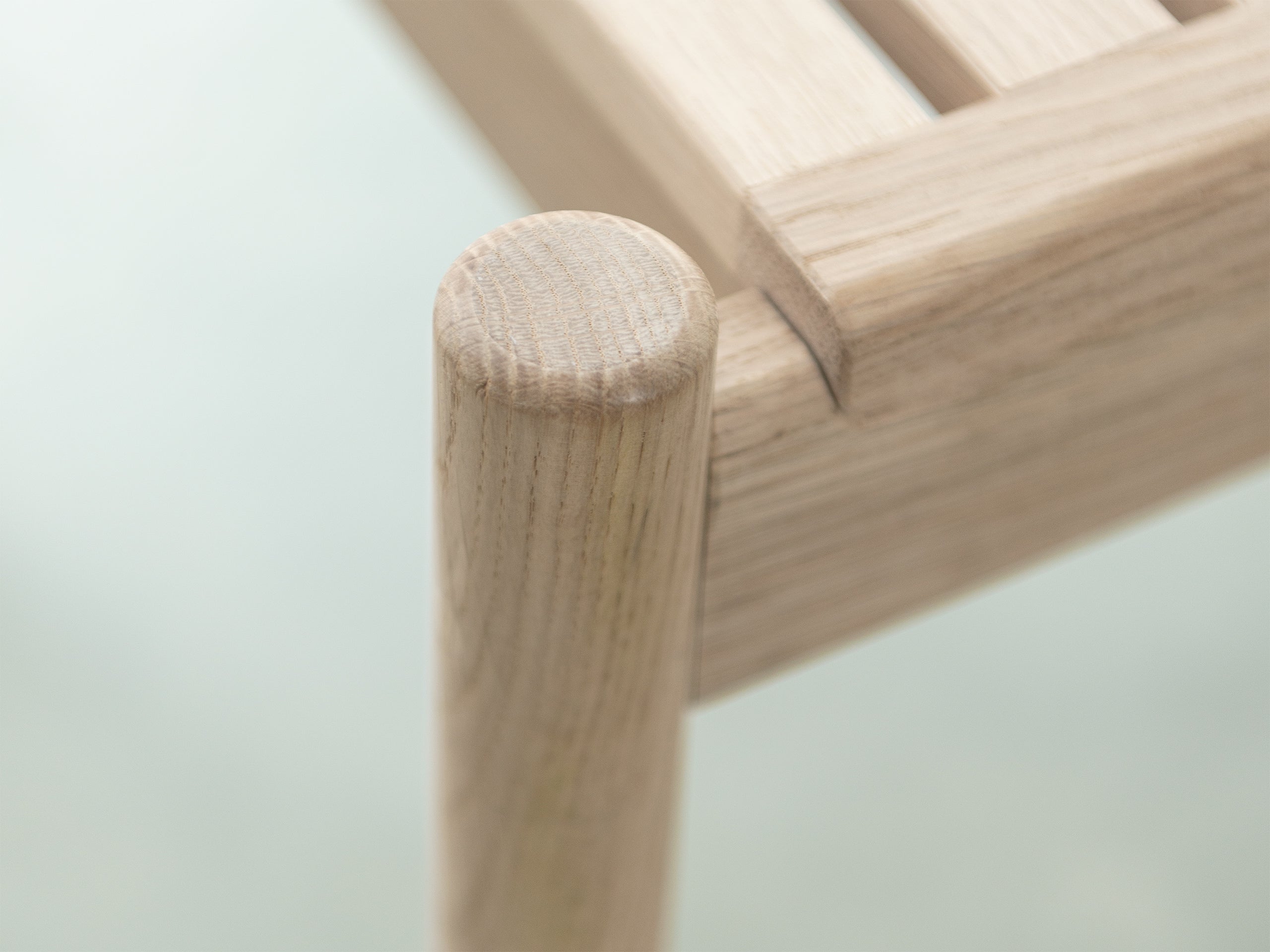 light oak bench close-up of rounded tubular leg